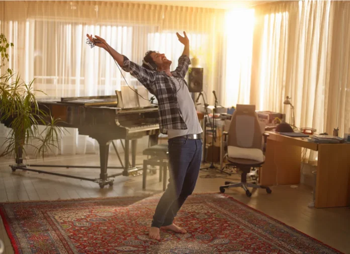 Happy-man-dancing-in-a-living-room-490593a A happy man dancing in living room