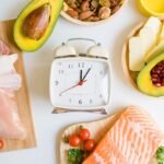 Intermittent Fasting vs. Traditional Diets: Which Is Better? Intermittent fasting and Healthy food. Concept.Alarm clock
