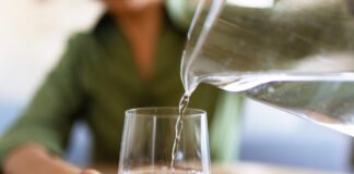 Hydration Hacks: How Much Water Do You Really Need? Jug of water pouring into glass