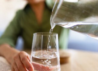 Hydration Hacks: How Much Water Do You Really Need? Jug of water pouring into glass