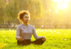 5-Minute Meditation Routines That Reduce Stress Fast Woman meditating on grass