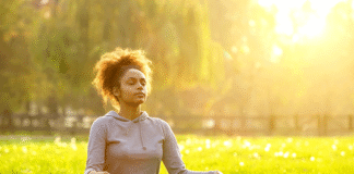 5-Minute Meditation Routines That Reduce Stress Fast Woman meditating on grass