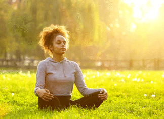 5-Minute Meditation Routines That Reduce Stress Fast Woman meditating on grass