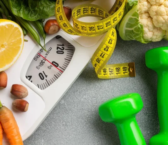 How to Boost Your Metabolism Naturally After 30 weight scale, with tape measure and dumbells