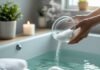 How to Use Epsom Salt for Muscle Pain and Detox Baths Epsom salt being poured into the bath-tub