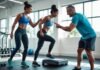 How to Break Through a Weight Loss Plateau Three adults in a gym working together with one woman stepping on a scale and a trainer showing progress on a tablet.