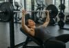 How to Tone Chest Muscles Naturally A woman bench pressing a barbell